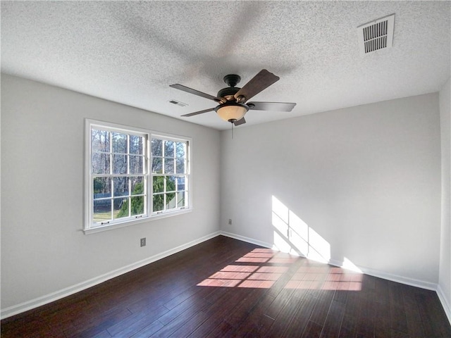 unfurnished room with a textured ceiling, dark hardwood / wood-style flooring, and ceiling fan