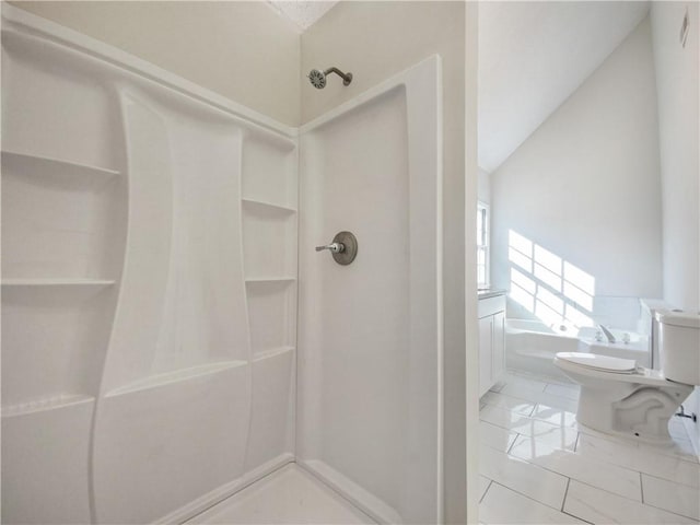 bathroom with plus walk in shower, vaulted ceiling, and toilet