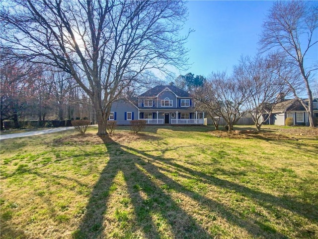 view of front of property with a front lawn and covered porch