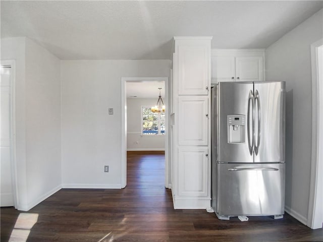 kitchen with white cabinets, dark hardwood / wood-style floors, stainless steel refrigerator with ice dispenser, and a notable chandelier