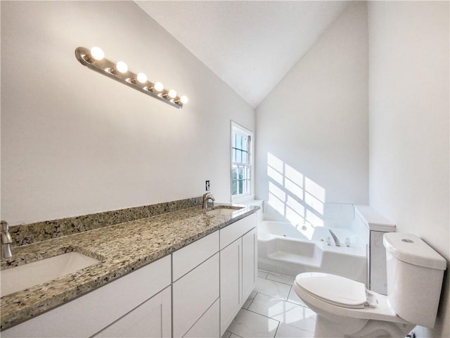 bathroom with vanity, vaulted ceiling, tile patterned flooring, a washtub, and toilet