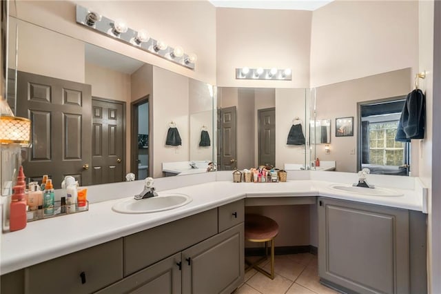 407 The Crossings Ln, Woodstock, GA 30189 - full bathroom featuring a towering ceiling, tile patterned floors, decorative backsplash, and vanity