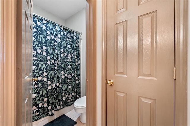 407 The Crossings Ln, Woodstock, GA 30189 - bathroom featuring a shower with curtain, toilet, and tile patterned floors