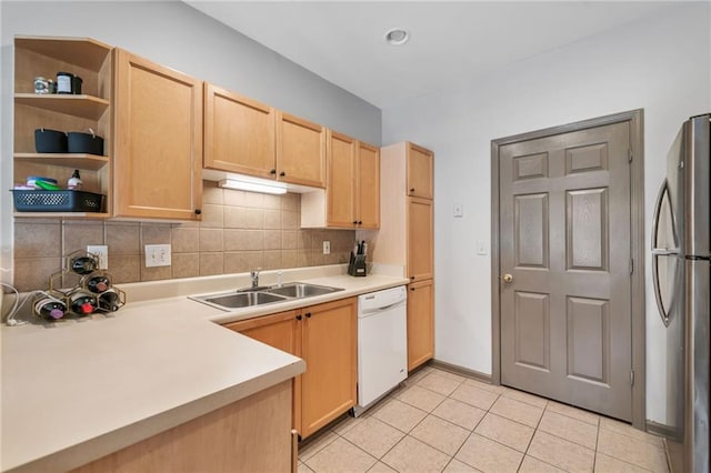 407 The Crossings Ln, Woodstock, GA 30189 - kitchen featuring a sink, freestanding refrigerator, white dishwasher, light brown cabinets, and decorative backsplash