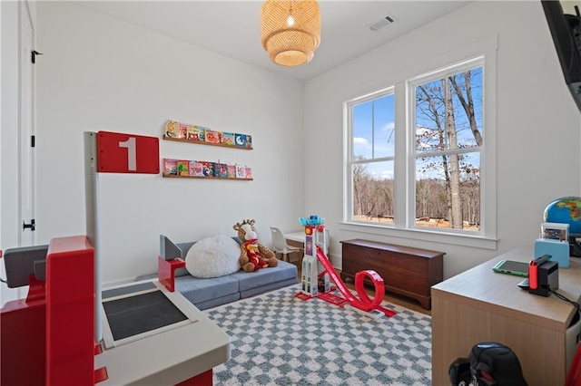 recreation room with visible vents and carpet flooring