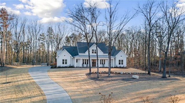 modern farmhouse style home with a front lawn