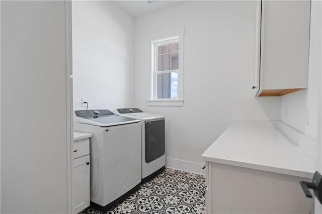 laundry room featuring washer and dryer, baseboards, and cabinet space