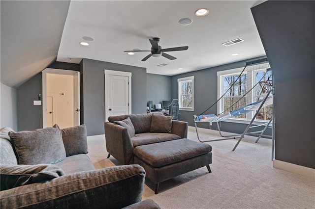 living area with light colored carpet, visible vents, and baseboards