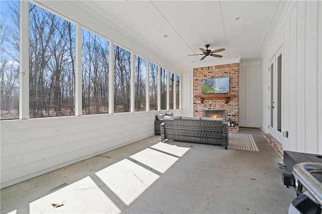 view of patio with an outdoor living space with a fireplace and a ceiling fan