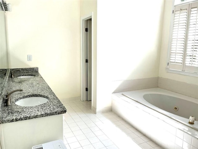 bathroom featuring vanity, tiled bath, and tile patterned flooring