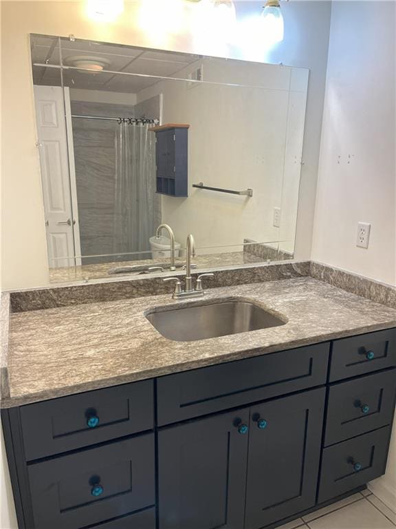 bathroom with vanity, a shower with shower curtain, and tile patterned flooring