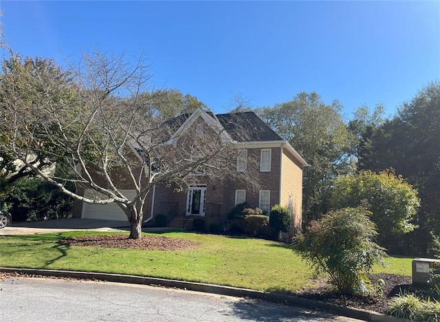 view of front of house with a front lawn and a garage