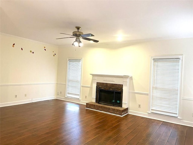 unfurnished living room featuring dark wood-type flooring, a fireplace, and ceiling fan