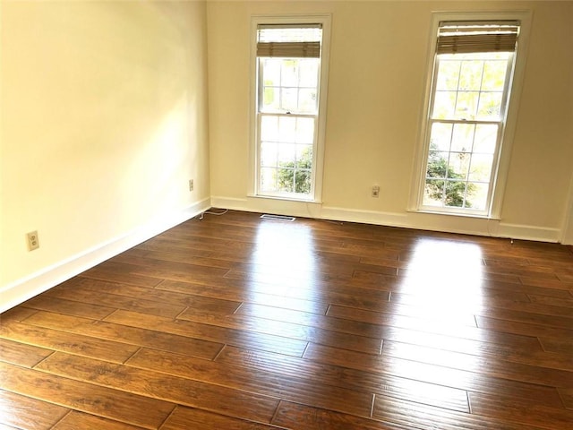 unfurnished room with dark hardwood / wood-style floors