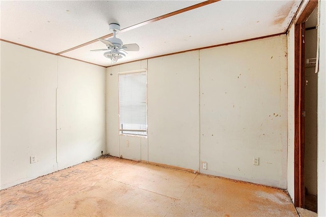 unfurnished room featuring crown molding and a ceiling fan