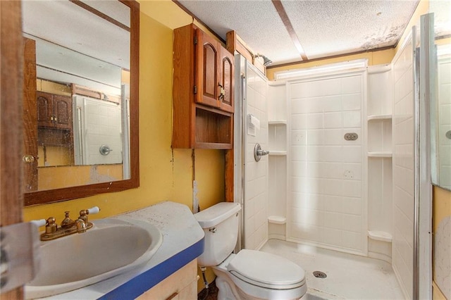 bathroom with a textured ceiling, a stall shower, vanity, and toilet