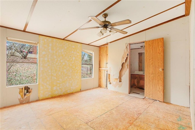 empty room with a ceiling fan and ornamental molding