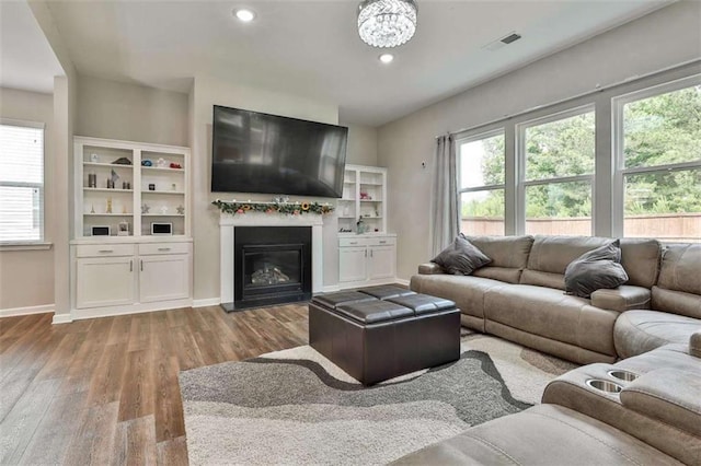 8 Unbridled Way, Newnan, GA 30263 - living room featuring wood finished floors, a glass covered fireplace, recessed lighting, and baseboards