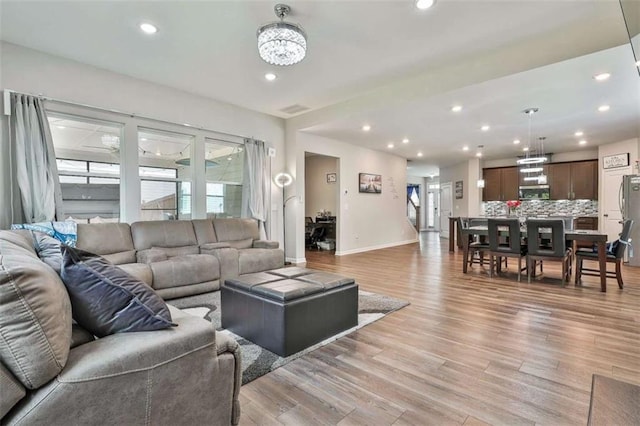 8 Unbridled Way, Newnan, GA 30263 - living area featuring light wood finished floors, baseboards, a chandelier, and recessed lighting