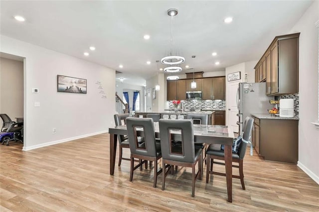8 Unbridled Way, Newnan, GA 30263 - dining room featuring light wood-style flooring, recessed lighting, baseboards, and a chandelier