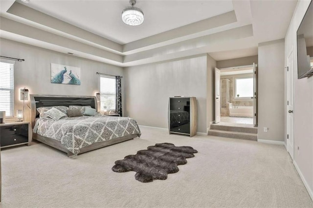 8 Unbridled Way, Newnan, GA 30263 - carpeted bedroom featuring a raised ceiling, baseboards, multiple windows, and connected bathroom