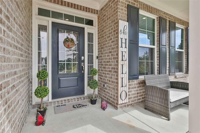 8 Unbridled Way, Newnan, GA 30263 - doorway to property featuring covered porch and brick siding