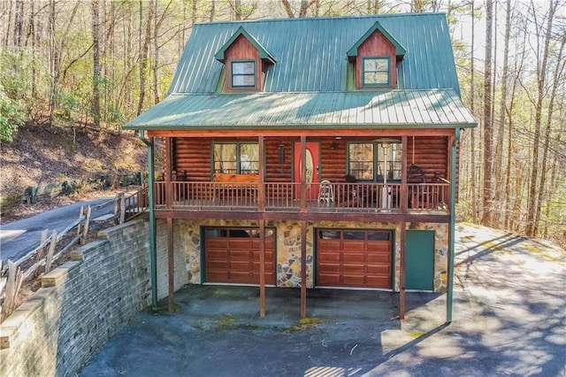 log-style house with a garage and a porch