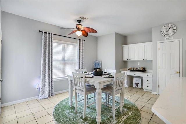dining space featuring light tile patterned flooring, baseboards, a ceiling fan, and visible vents