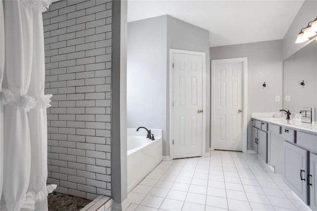 bathroom with a tile shower, tile patterned flooring, a garden tub, and vanity