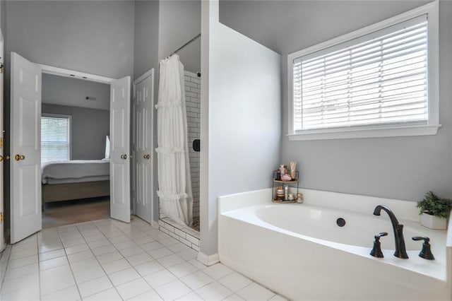 ensuite bathroom with tile patterned floors, a garden tub, ensuite bath, and a stall shower