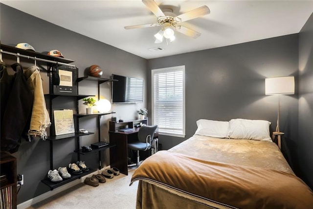 carpeted bedroom featuring visible vents and ceiling fan