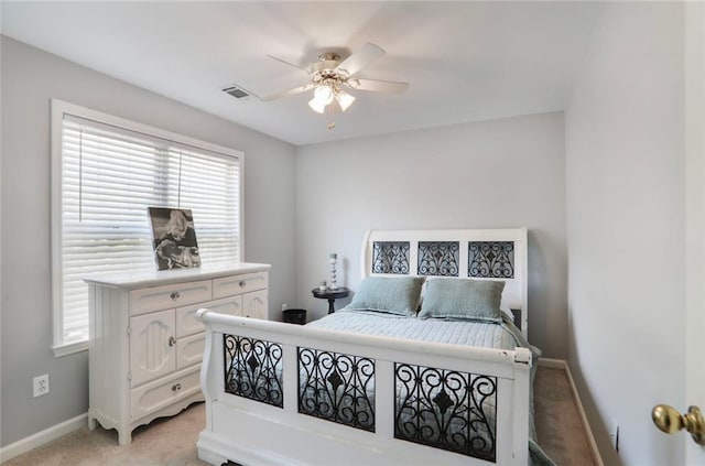 bedroom featuring visible vents, baseboards, a ceiling fan, and light carpet