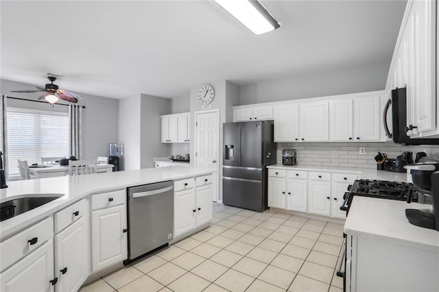 kitchen featuring white cabinetry, black appliances, light countertops, and ceiling fan