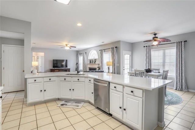 kitchen with dishwasher, open floor plan, ceiling fan, and a sink