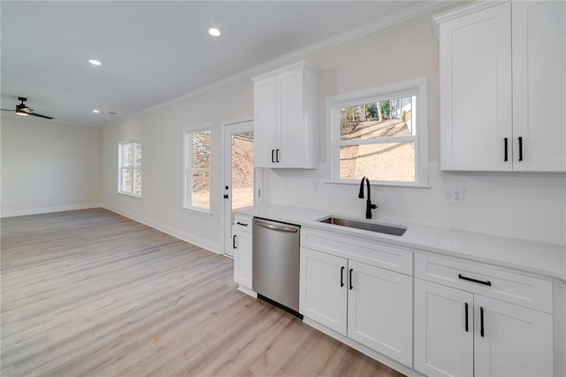 kitchen featuring ceiling fan, tasteful backsplash, stainless steel dishwasher, white cabinets, and sink