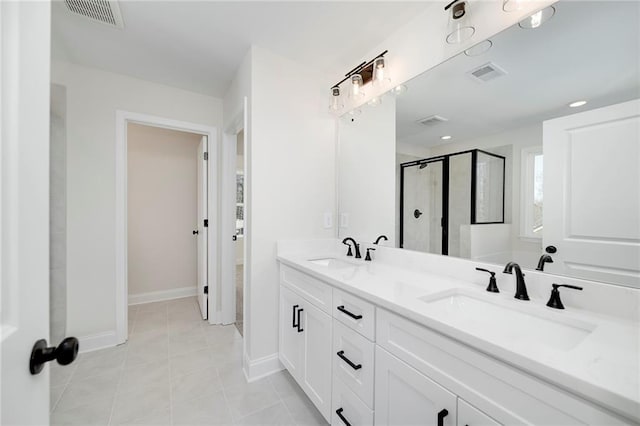 bathroom featuring vanity, tile patterned flooring, and a shower with door