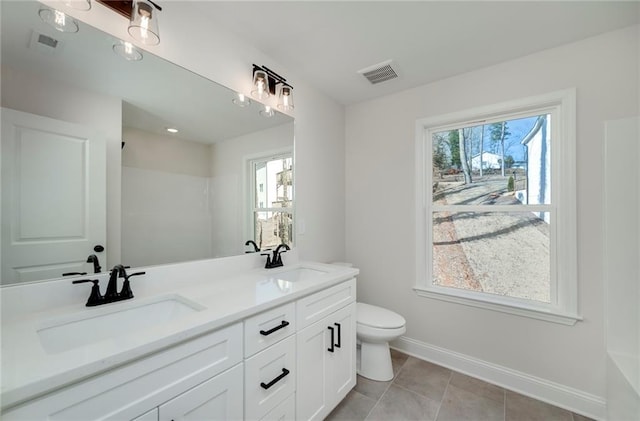 bathroom featuring toilet, vanity, and tile patterned floors