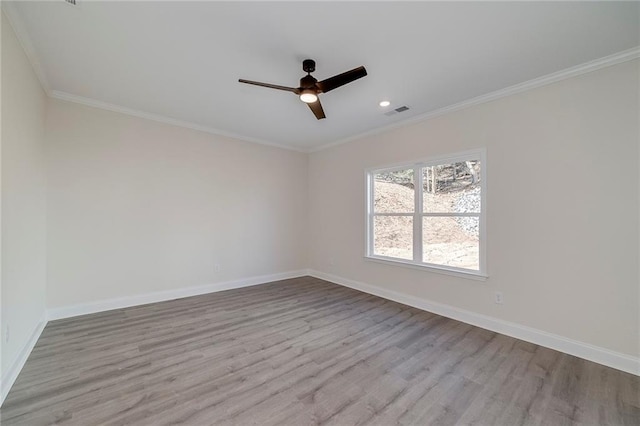 spare room featuring ceiling fan, ornamental molding, and light hardwood / wood-style floors