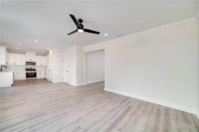 unfurnished living room with ceiling fan, crown molding, and light hardwood / wood-style floors