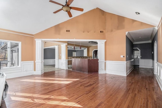 unfurnished living room featuring ornate columns, high vaulted ceiling, hardwood / wood-style flooring, and ceiling fan