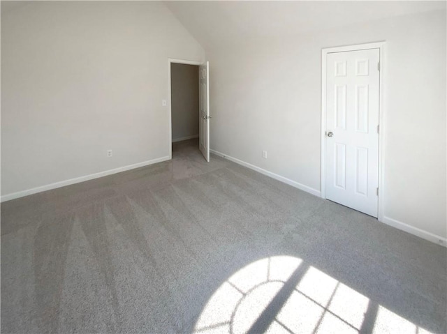 unfurnished bedroom with baseboards, carpet floors, and vaulted ceiling