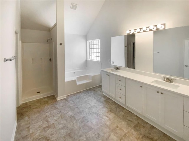bathroom with a bath, double vanity, a sink, and a shower