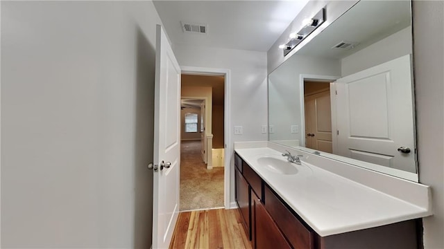 bathroom featuring hardwood / wood-style floors and vanity