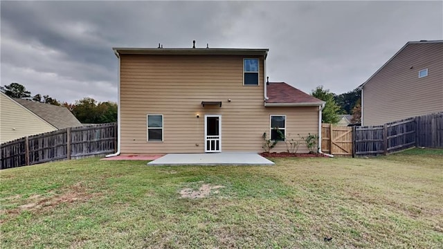 back of property with a patio and a yard