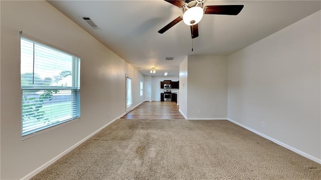 empty room featuring light carpet and ceiling fan