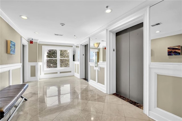 hall with visible vents, recessed lighting, elevator, crown molding, and a decorative wall