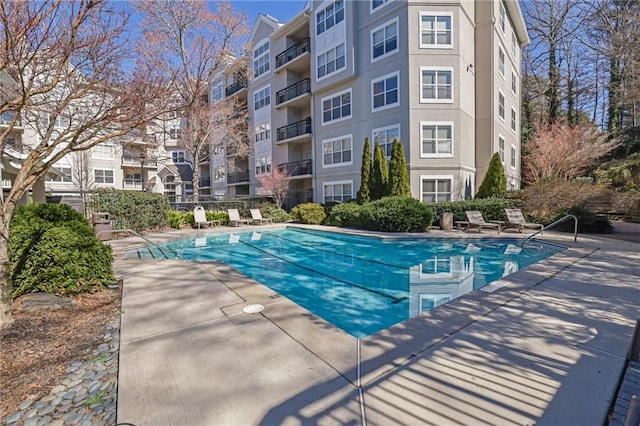 pool featuring fence and a patio area