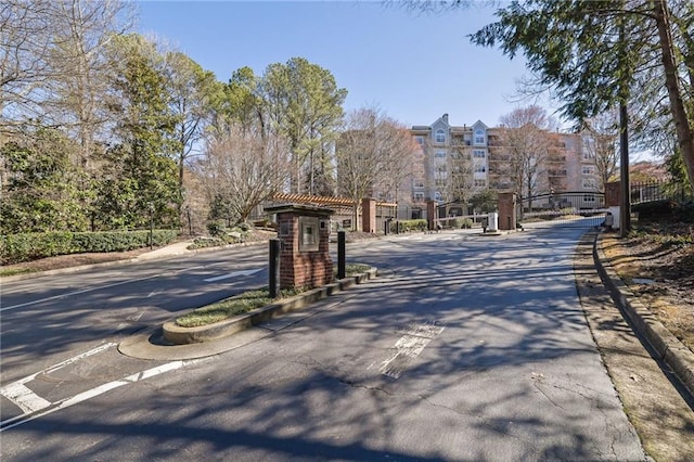 view of street featuring curbs, a gated entry, and a gate