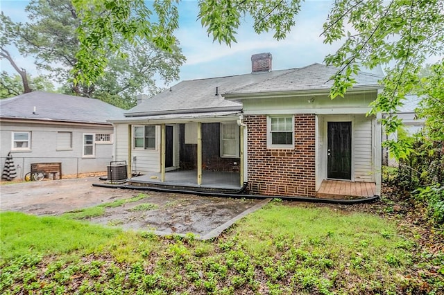 1615 Stokes Ave SW, Atlanta, GA 30310 - rear view of property featuring a patio, a chimney, and brick siding