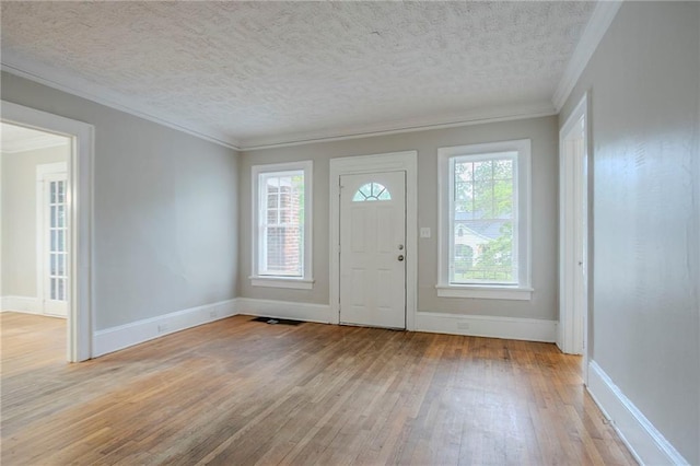 1615 Stokes Ave SW, Atlanta, GA 30310 - entrance foyer with light wood-style floors, crown molding, baseboards, and a textured ceiling